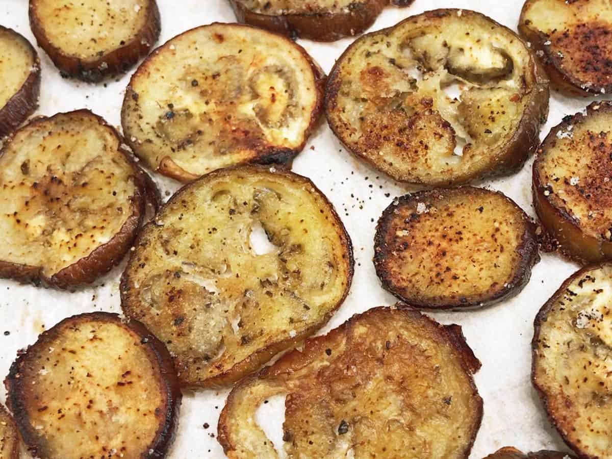 The eggplant chips are ready on the baking sheet.