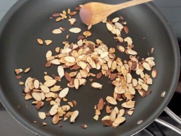 Toasting almonds in a skillet.