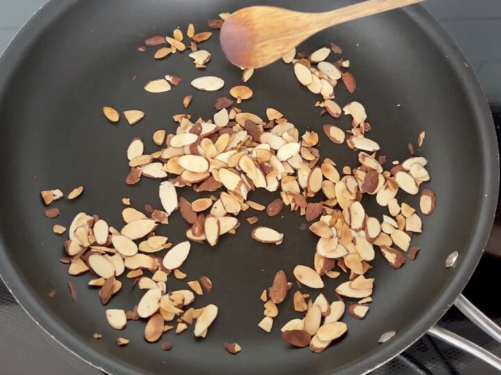 Toasting almonds in a skillet.
