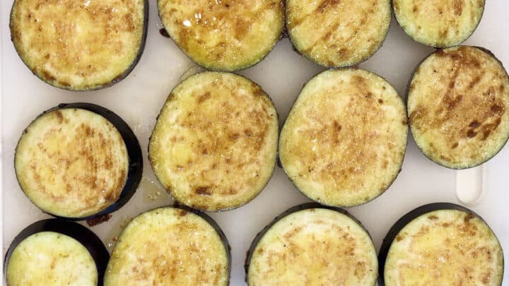 The eggplant slices are coated in the marinade.