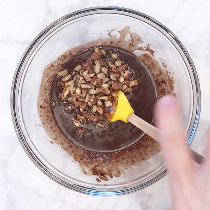 Mixing in chopped nuts.