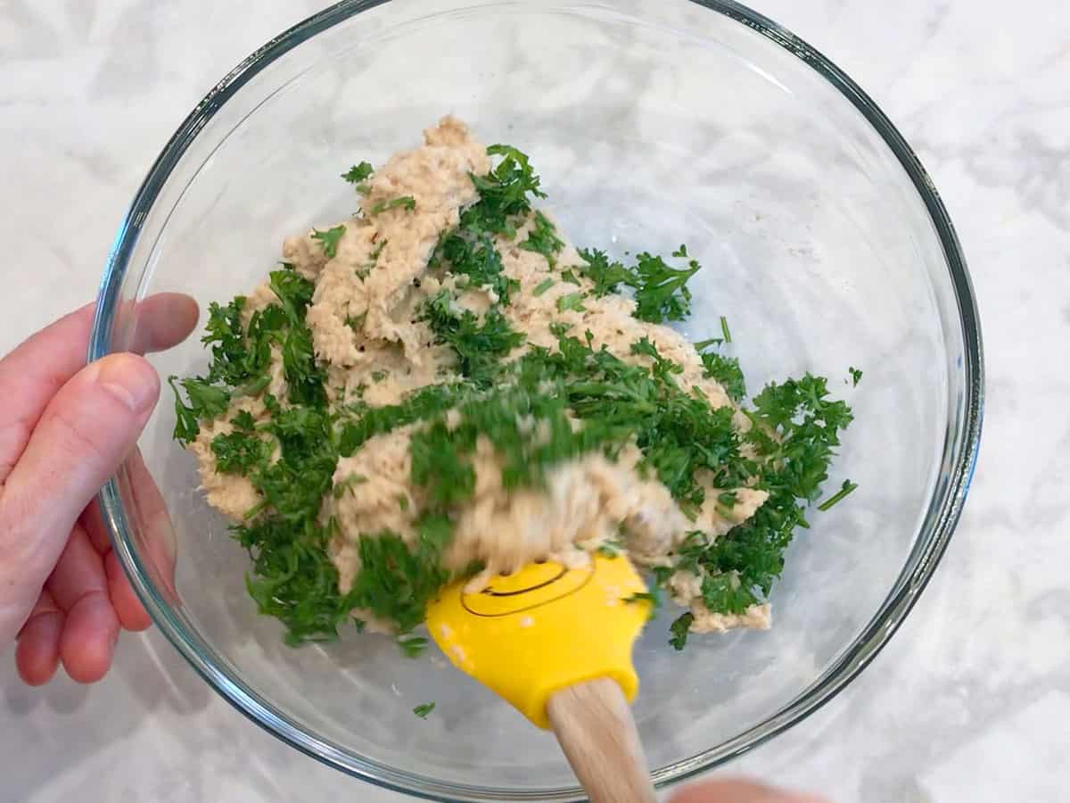 Adding parsley to the mixture.