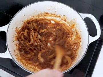 Adding the spices to the saucepan.