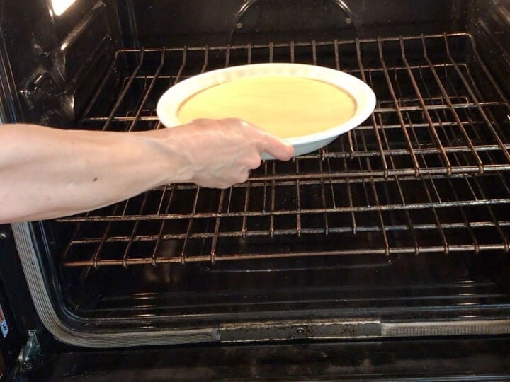 Placing the cake in the oven.