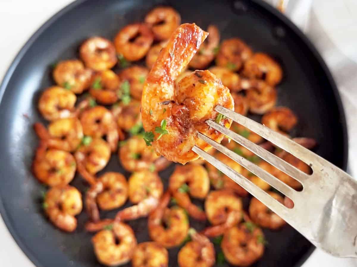 A closeup of a sautéed shrimp that shows how juicy it is.