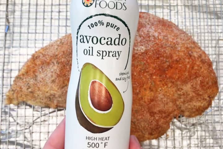 Spraying turkey breast with oil.