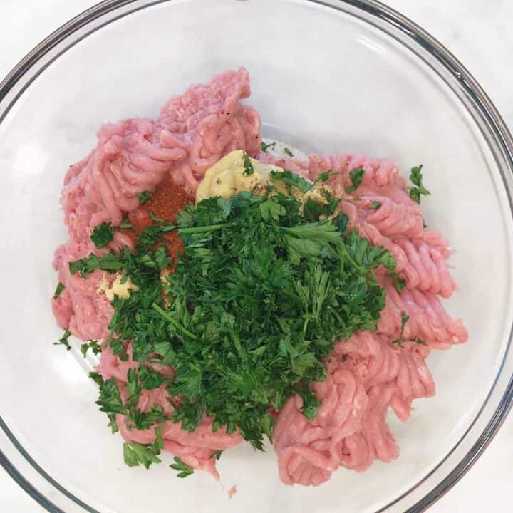 The ingredients for turkey burgers in a bowl.