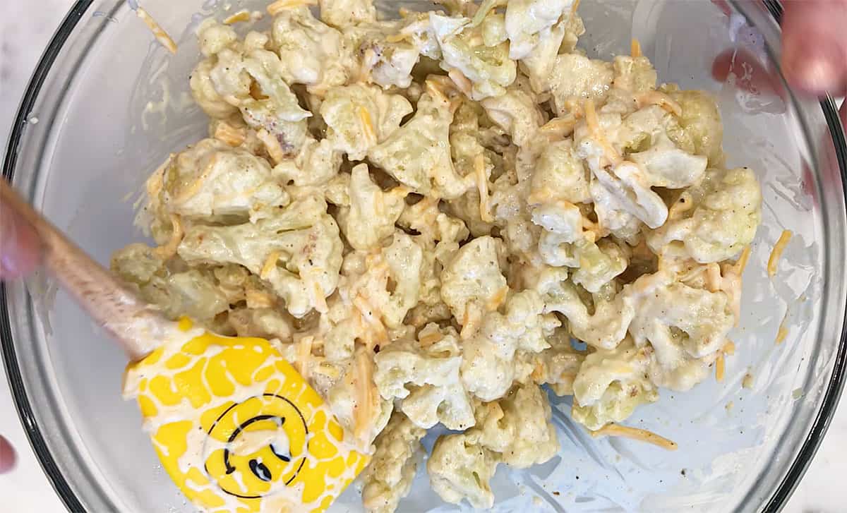 Mixing the sauce and the roasted cauliflower.