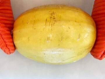 Removing the squash from the microwave.