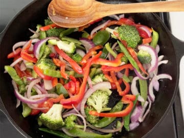 Cooking veggies in a skillet.