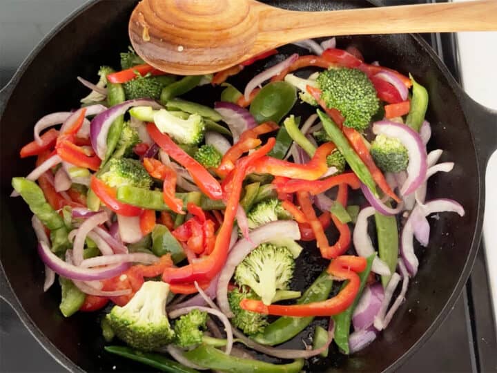 Cooking veggies in a skillet.