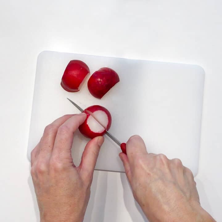 Cutting the radishes.