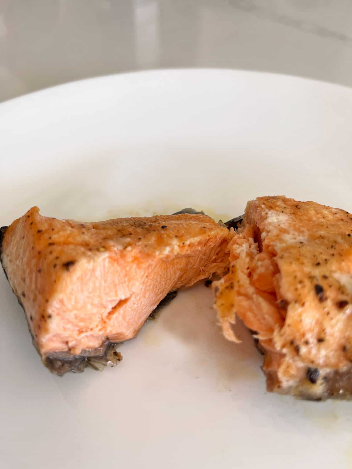 The inside of the overcooked salmon fillet appears dry.