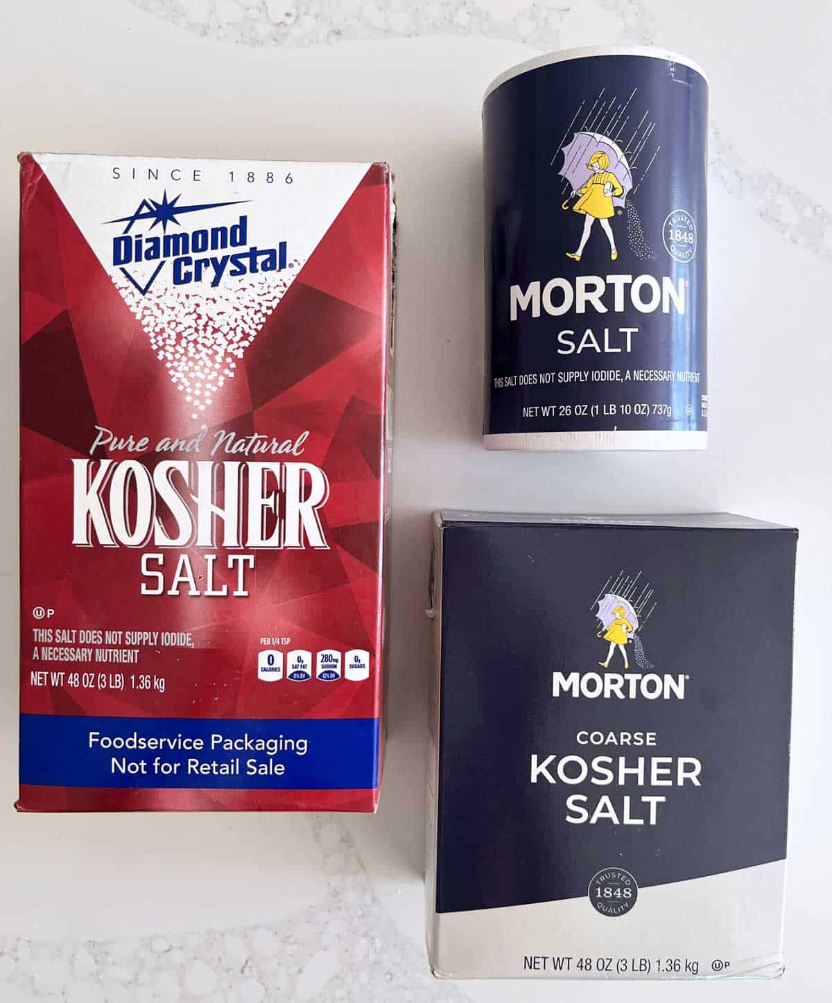 Three salt packages: Diamond Crystal, Morton kosher salt, and Morton table salt.