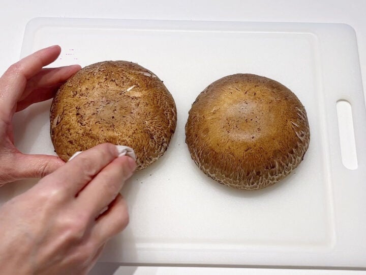 Cleaning portobello mushrooms.