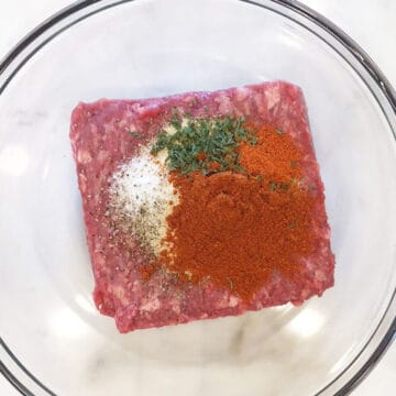 Ground bison and spices in a bowl.