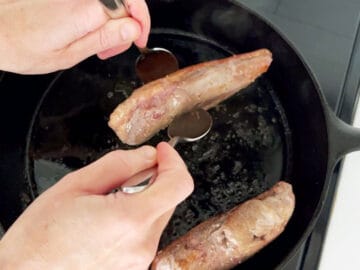 Cooking the duck breast edges.