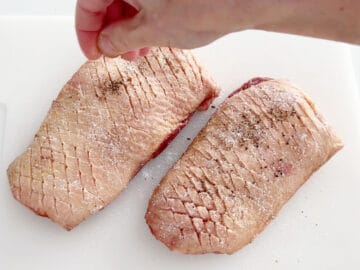 Seasoning the duck.