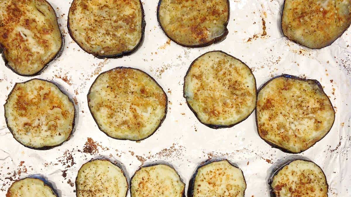 Baked eggplant slices on a baking sheet.