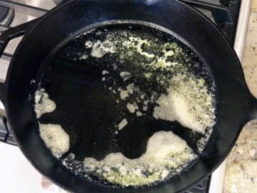 Heating butter in a skillet.