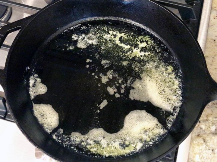 Heating butter in a skillet.