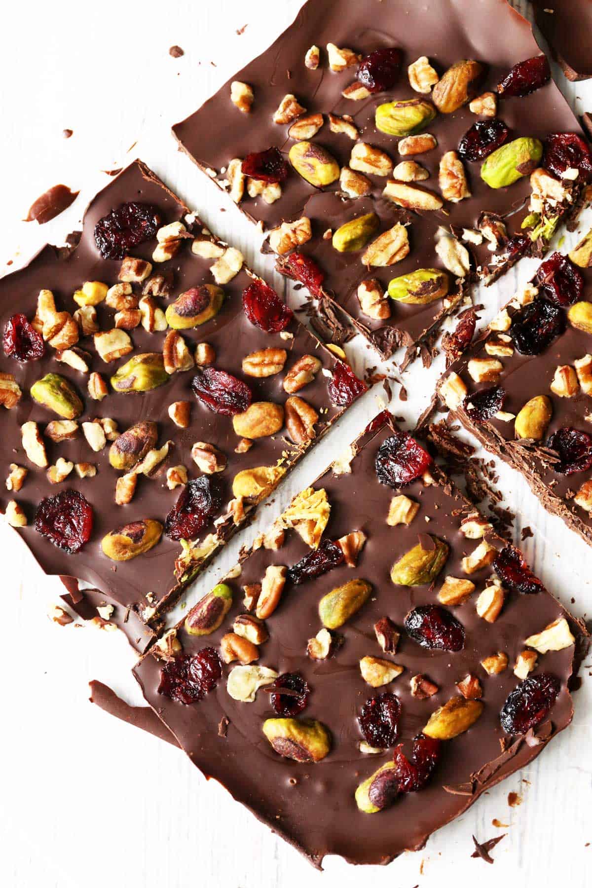 Chocolate bark topped with nuts and dried cranberries.
