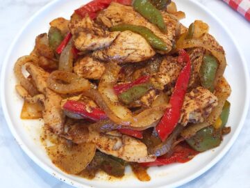 The fajitas are served on a plate.