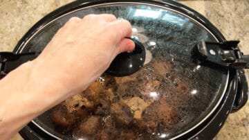 Keeping the oxtails warm in the slow cooker.