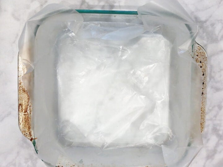 A baking dish with a wax paper overhang.