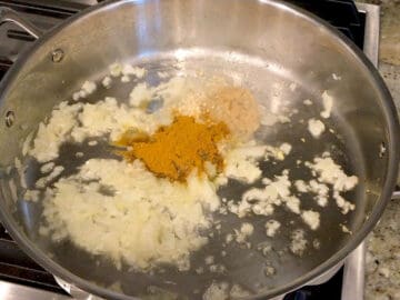 Cooking aromatics and spices in olive oil.