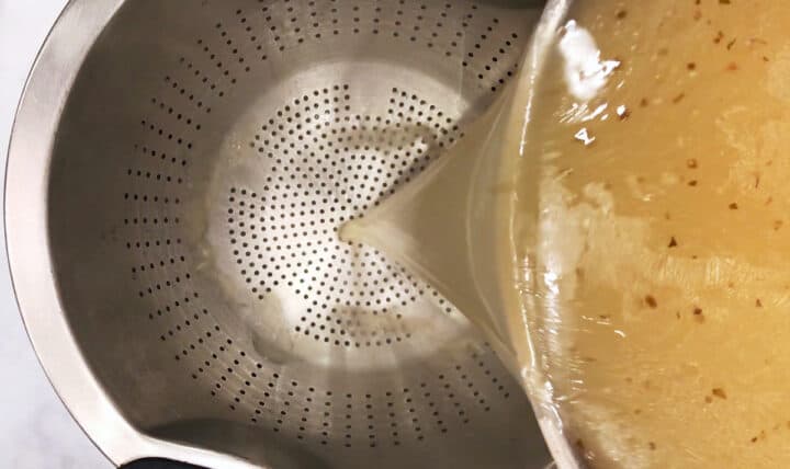 Straining the turkey stock.