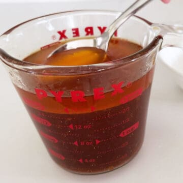 Skimming the fat from the top of the cooking liquids.