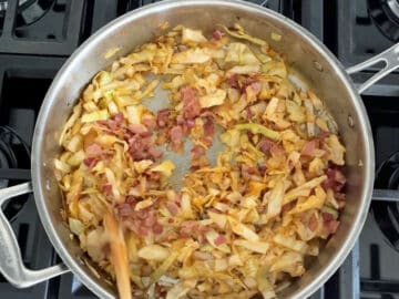 Adding the cooked bacon to the skillet.