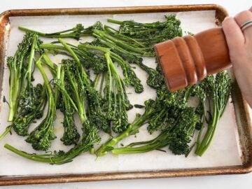 Seasoning the broccolini.