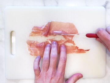 Cutting the prosciutto.