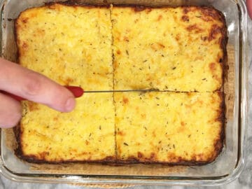 Cutting the casserole into four servings.