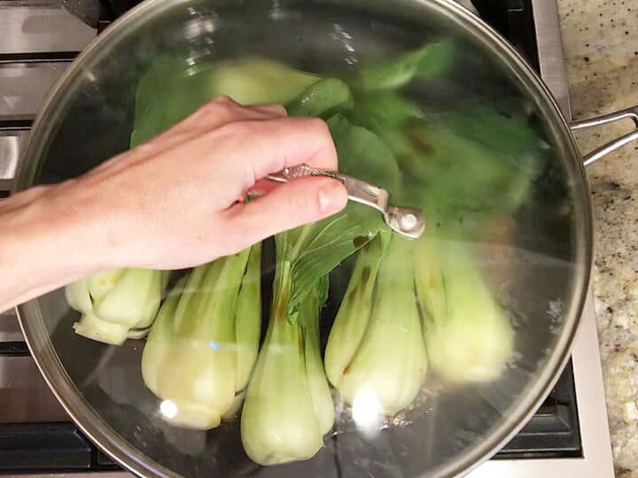 Covering the skillet with a lid.