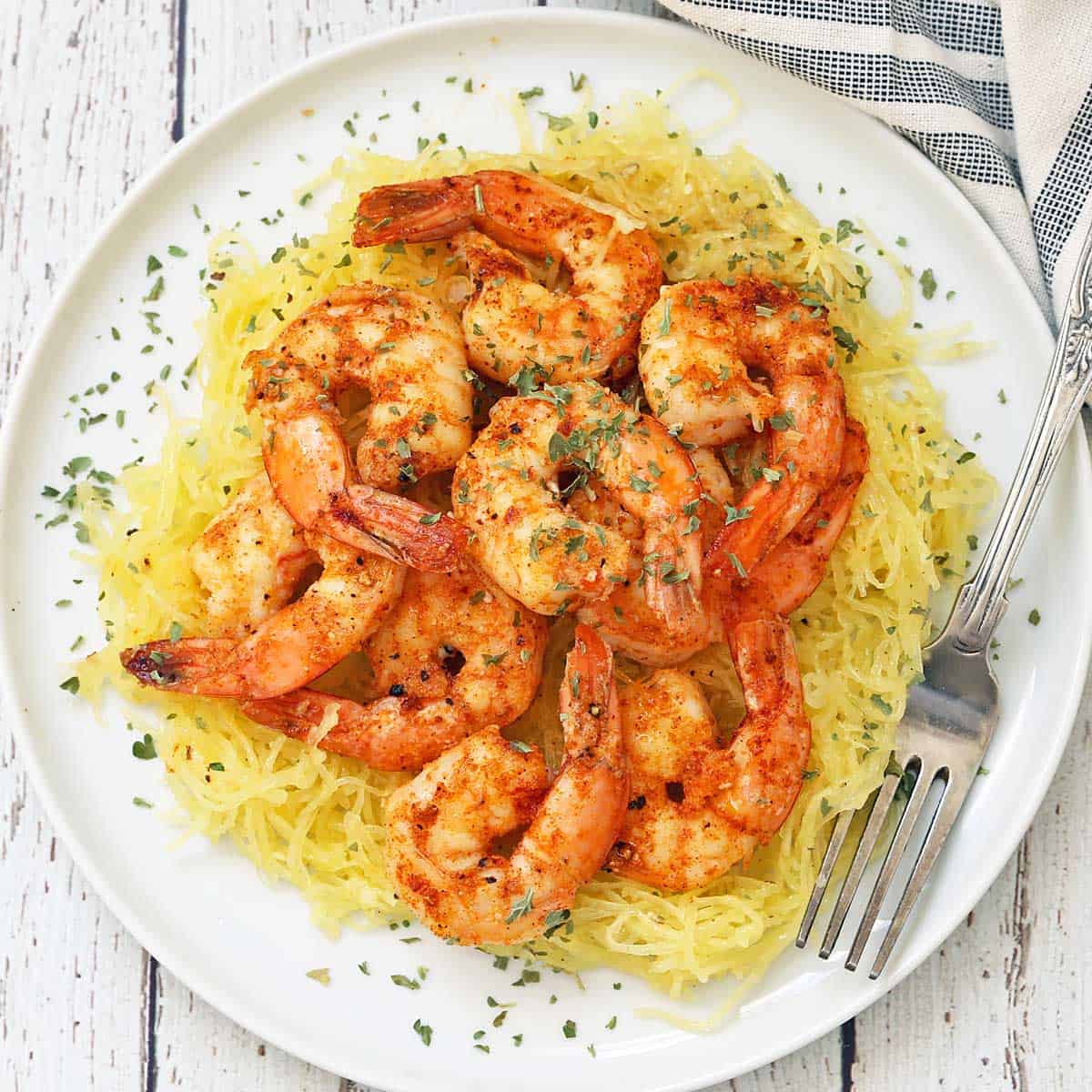 Spaghetti squash topped with shrimp.