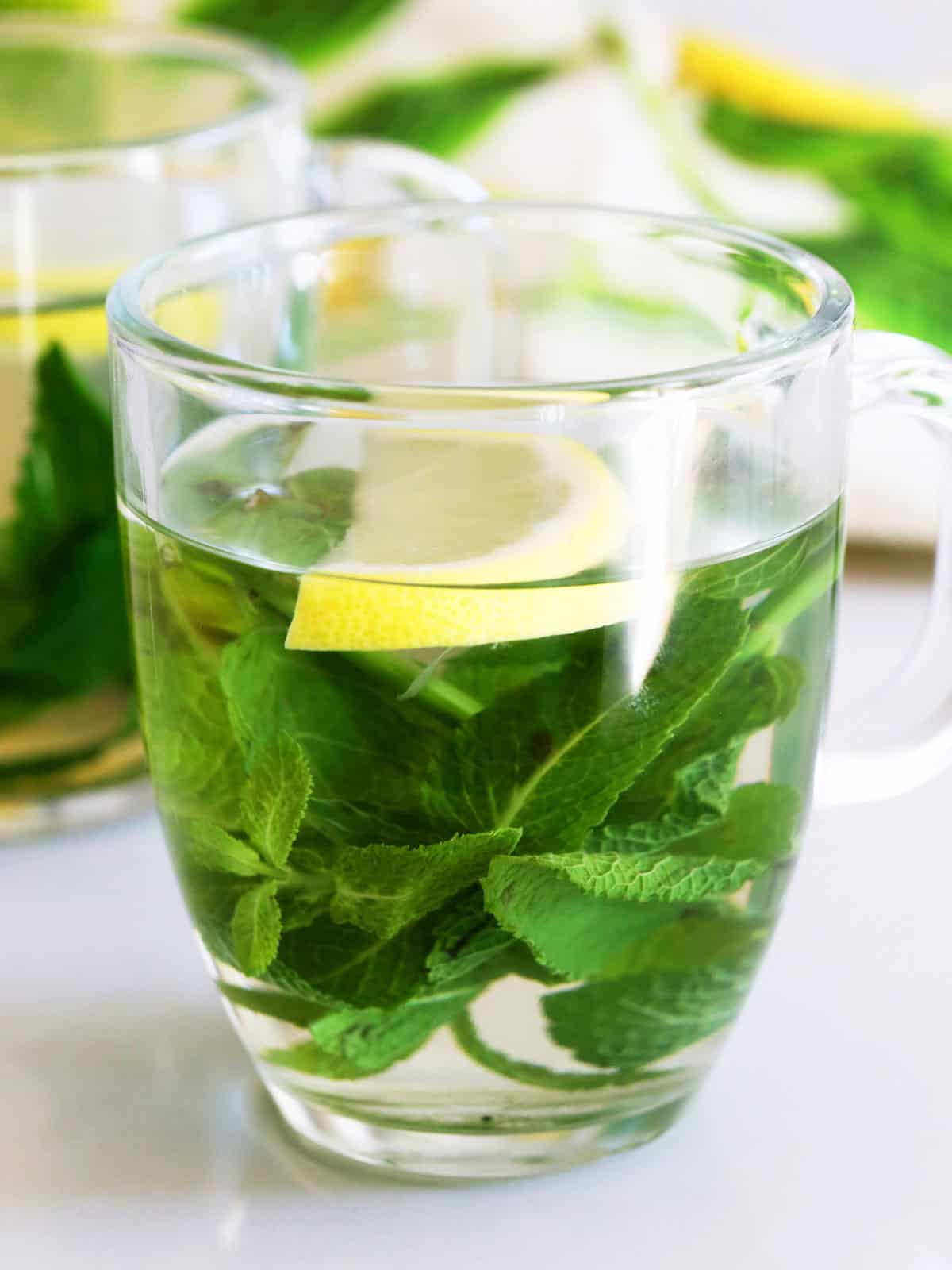 Mint tea is served garnished with a slice of lemon.