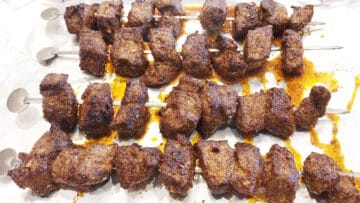 The kabobs are ready in the pan.