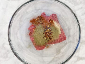 Beef sausage ingredients in a bowl.