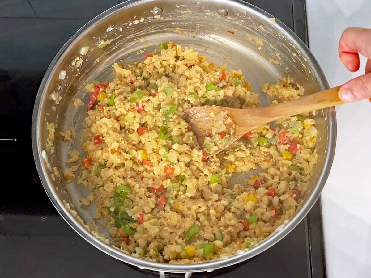Finishing cooking the cauliflower fried rice.