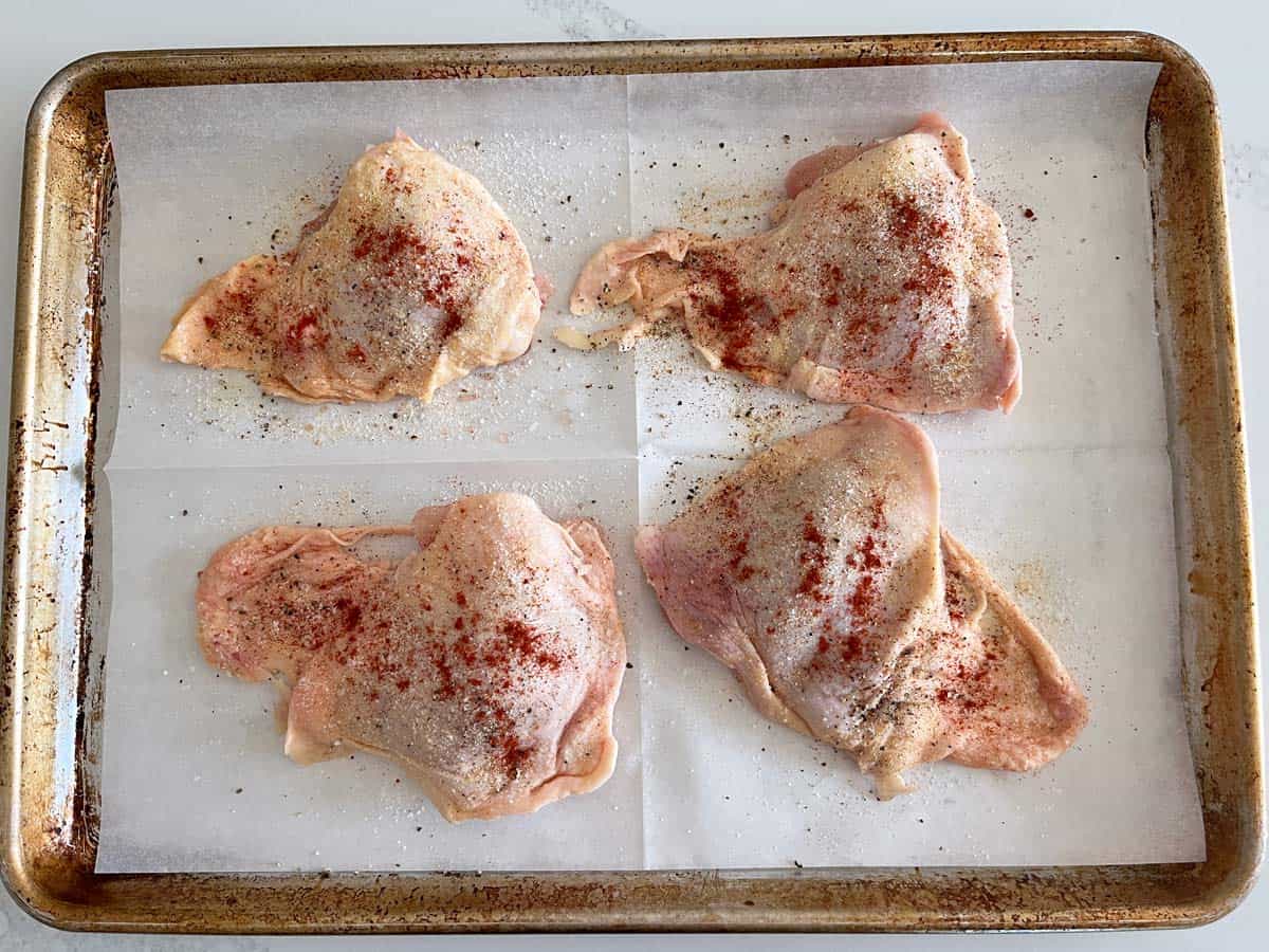 Spreading the skin on the baking sheet.