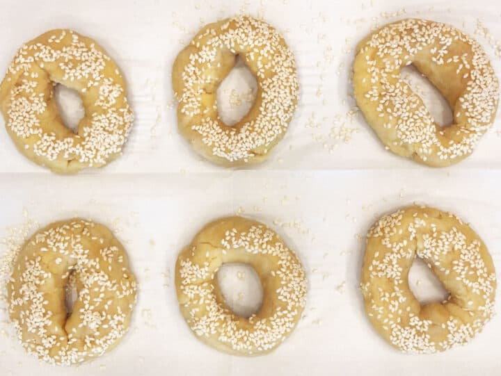 The bagels are on the baking sheet, ready for the oven.