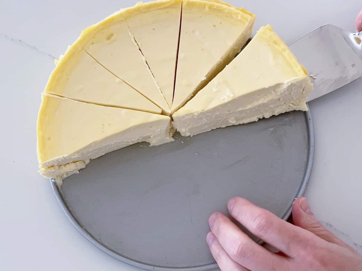 Lifting a slice of cake from the pan.