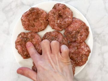 Making a dimple at the center of the sausage patties.