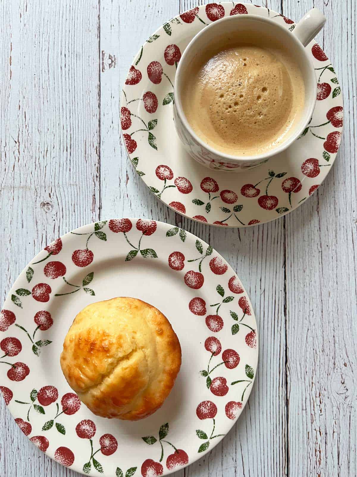 A protein muffin is served with coffee.