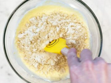 Adding the dry ingredients to the bowl.