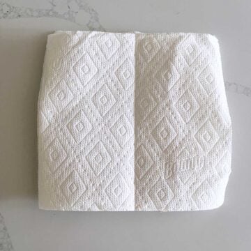 The bacon is covered with paper towels.