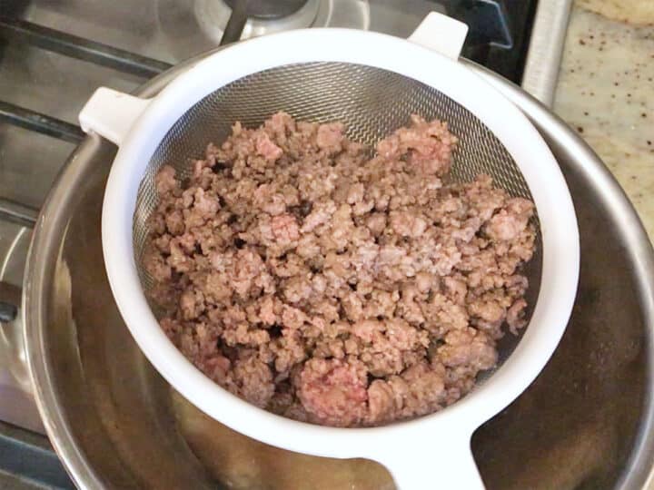 Draining the ground beef.